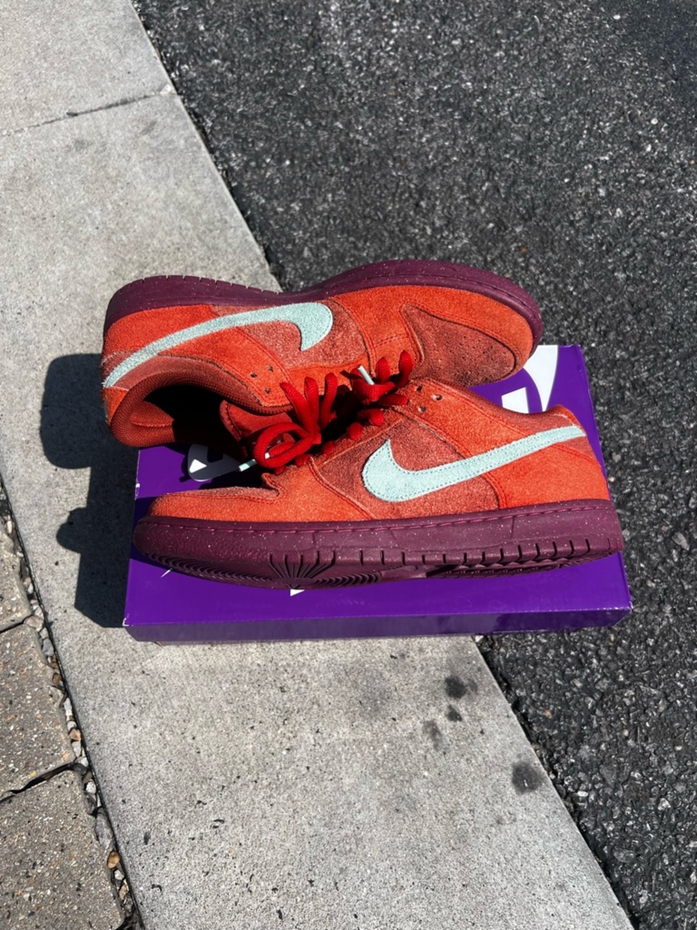 Nike sb dunk low mystic red with Mint Swoosh and Burgundy Sole.